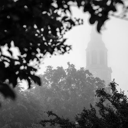A black and white photo shows Wait Chapel shrouded in mist